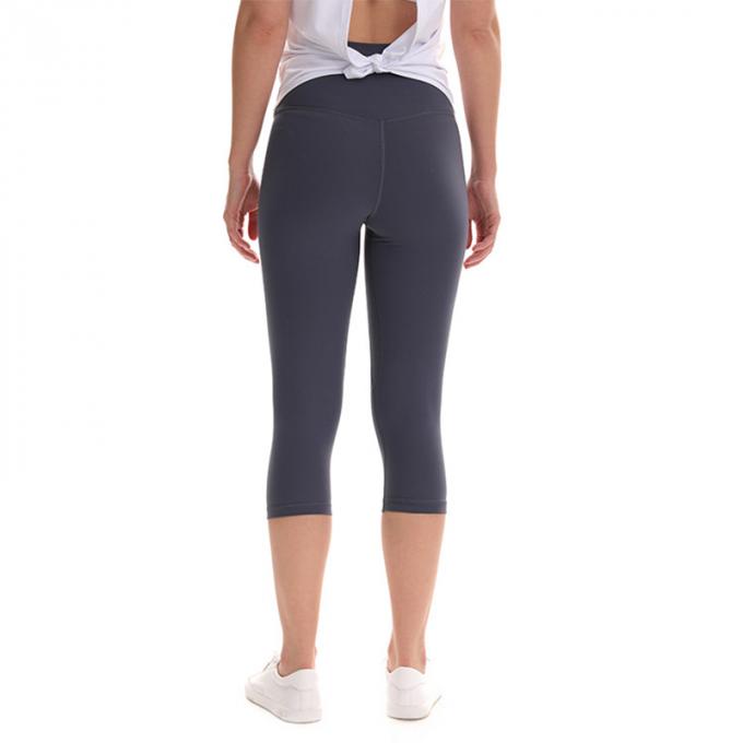 Pantaloni potati elastici di sport dei pantaloni delle ghette dell'anca di forma fisica di yoga delle donne senza cuciture su ordinazione delle ghette che eseguono le calzamaglia di formazione più la dimensione
